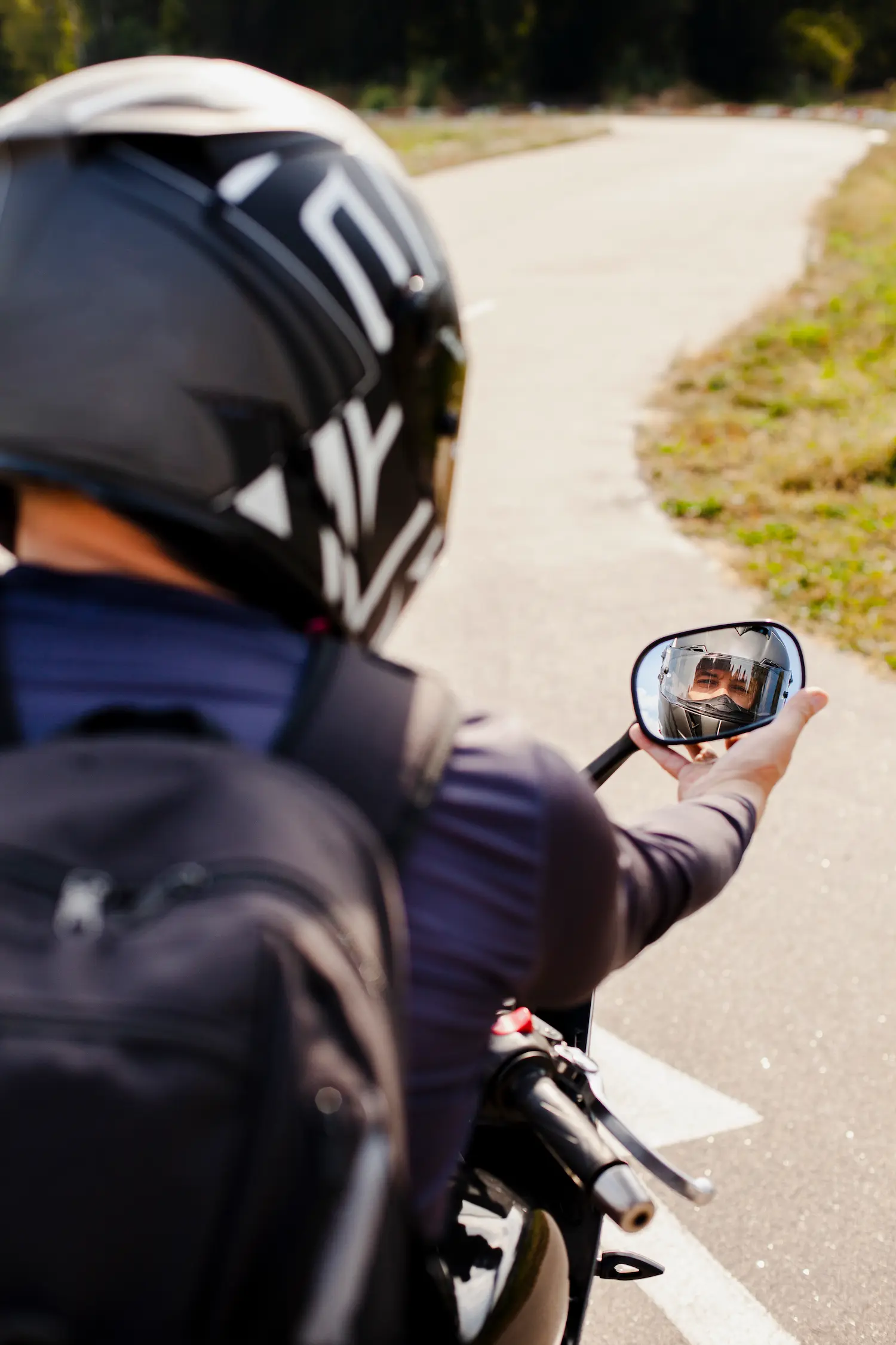 biker-fixing-motorbike-rearview-mirror